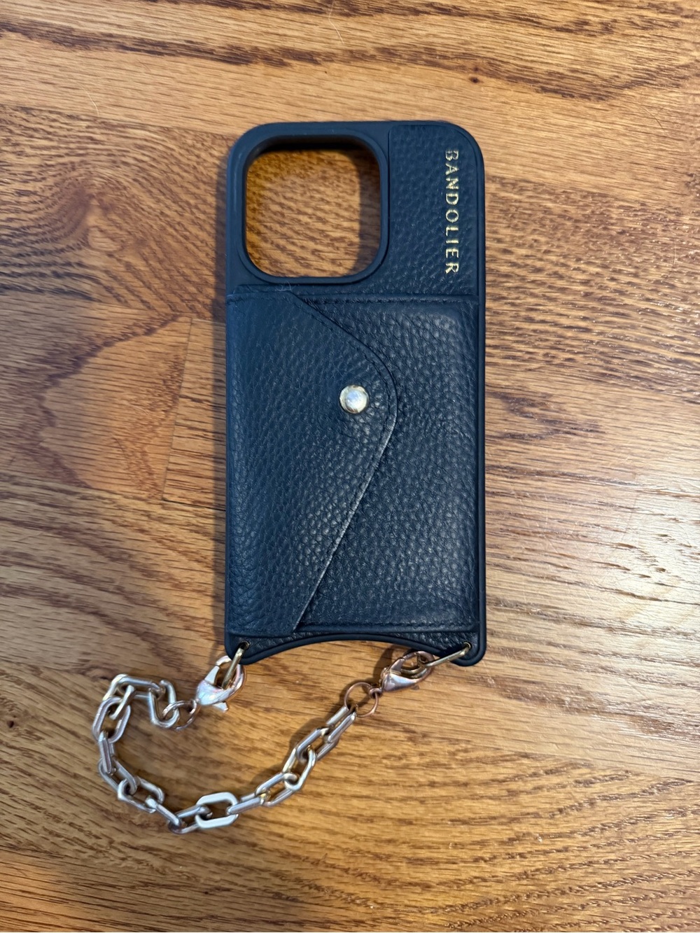 Bandolier iPhone 15 Pro case with gold wrist strap